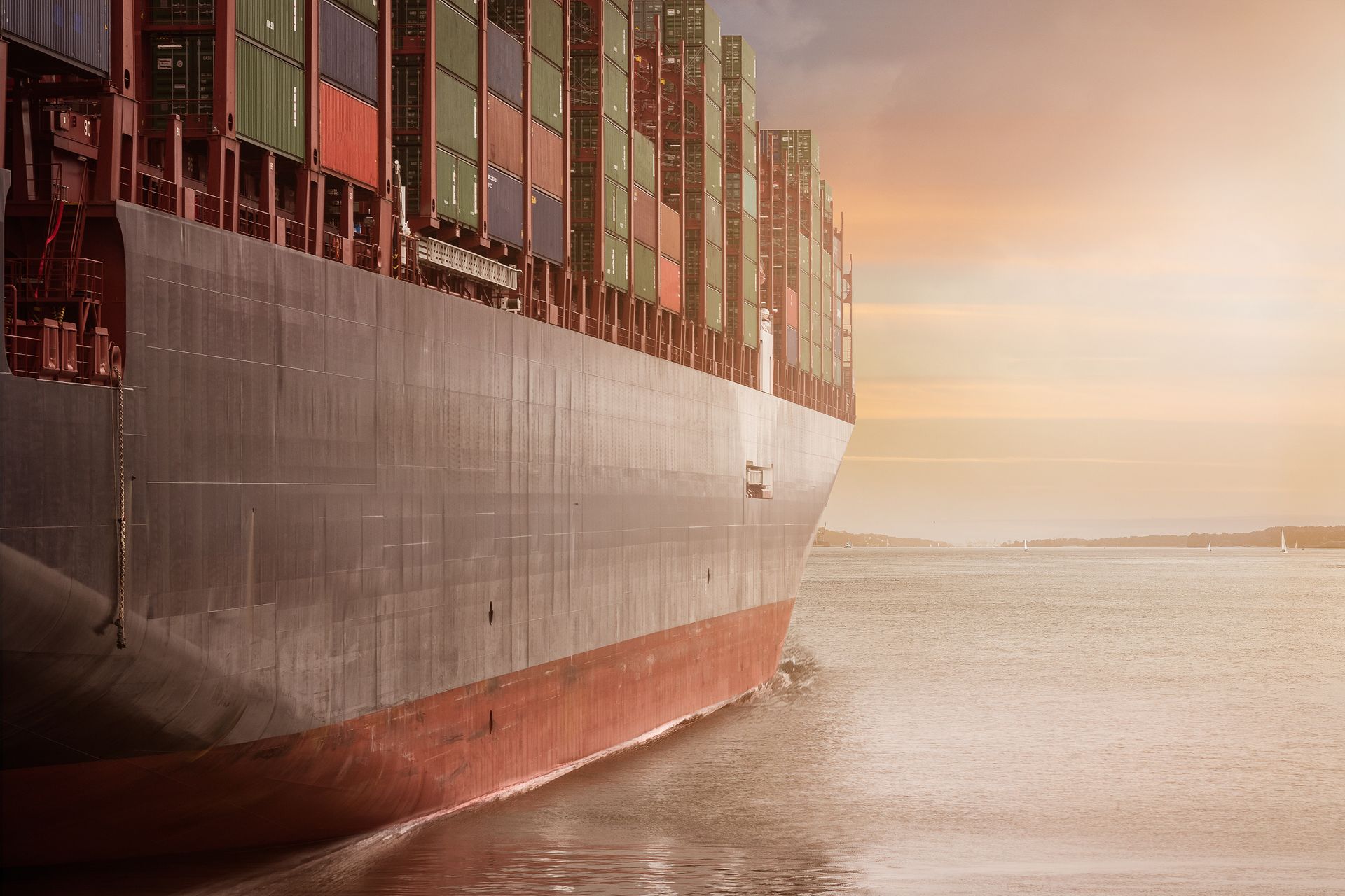 Laden container vessel sailing at golden hour